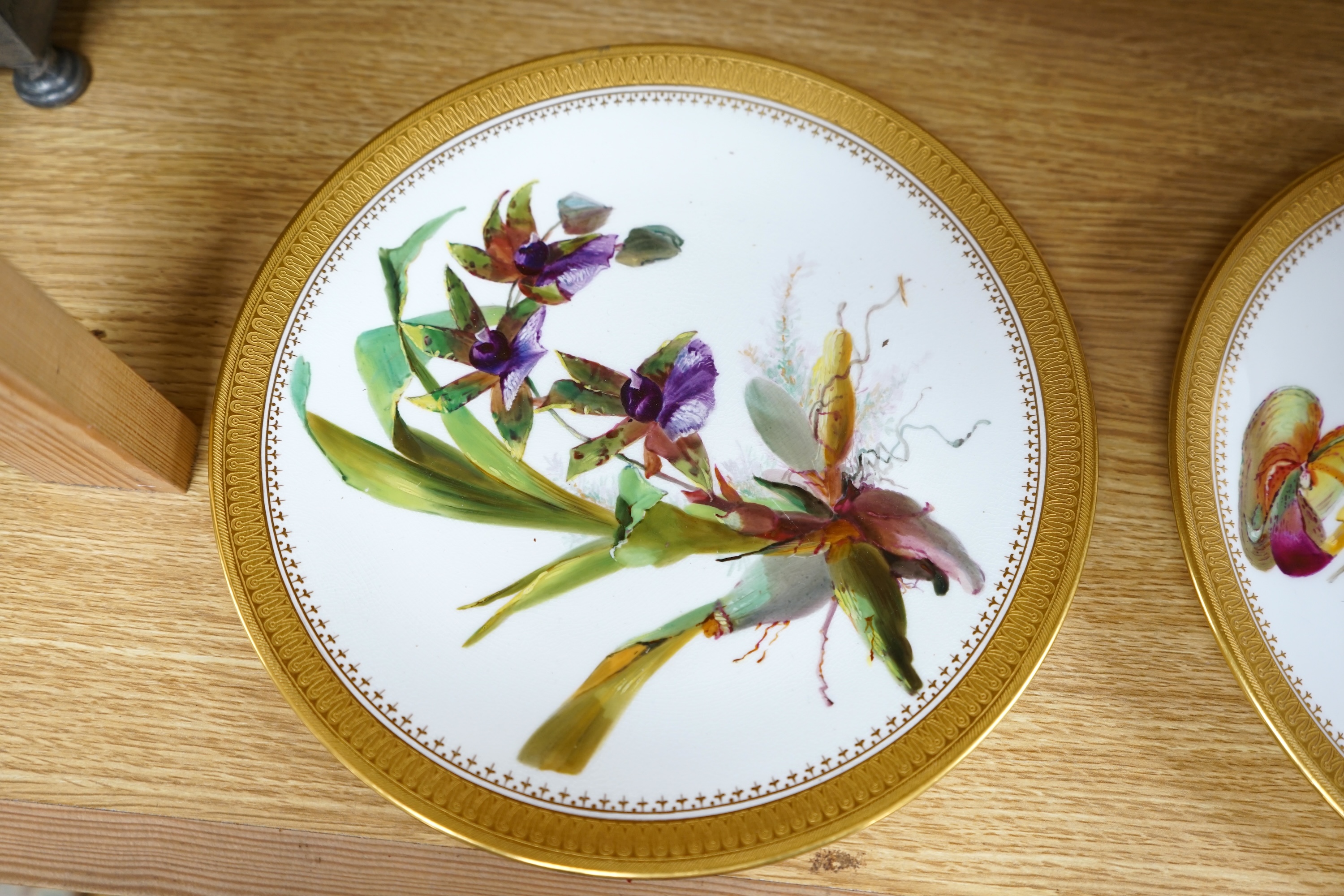 A pair of 19th century Mintons bone china plates, hand painted with flowers, 24cm in diameter. Condition - good